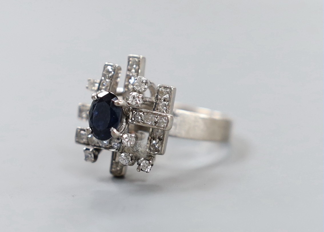 A modern 18k, sapphire and diamond cluster set dress ring, size K, gross weight 6 grams.